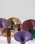 Colourful metallic finish vase on a white background