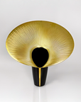 Decorative vase with gold and black design on a white background