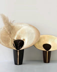 Two decorative vases with gold and black design on a light gray background