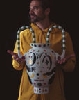 Person holding a decorative vase with a black background