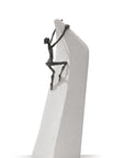 A Butzon Bercker sculpture of a man climbing on a rock, symbolizing the belief that everything is possible.