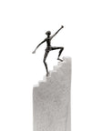 A Butzon & Bercker Sculpture Steps to Success of a successful man on top of a stairway.
