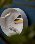 A Clock Haoshi Sparrow Round Yellow Gray with two sparrows on it.