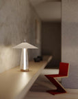 Modern table lamp on a wooden surface with a blurred background
