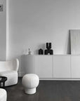 A black and white living room with a wooden floor featuring a 101Cph Cobra Double Medio Black 212006 vase by 101 Copenhagen.