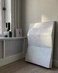 A black piece of furniture in front of a window with the 101Cph Cobra Double Medio Black 212006 vase by 101 Copenhagen.