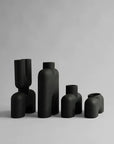 A collection of black vases, including the 101Cph Cobra Double Medio Black 212006 vase by 101 Copenhagen, showcased against a pristine white background.