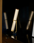 La Lampe Frechin table lamp by DCW Editions on a dark wooden sideboard