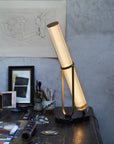 La Lampe Frechin table lamp by DCW Editions on a working table of an artist