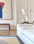 La Lampe Frechin table lamp by DCW Editions on a side table in a modern luxury living room.