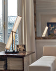 La Lampe Frechin table lamp by DCW Editions on a side table in a classical style living room.