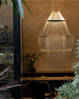 A lit up chandelier in front of a beige wall from DCW editions in modern style interiors