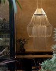 A lit up chandelier in front of a beige wall from DCW editions in modern style interiors