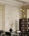 Modern chandelier hanging above a dining table in a stylish room.