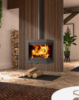 A modern square wood-burning fireplace with a black metal frame and a visible fire, set in a styled living room with wood slat walls, stacked firewood, and a black floor mat.