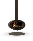 A modern floating wood burning fireplace with a dark matte finish, featuring a visible fire inside and a circular base plate on a white background.