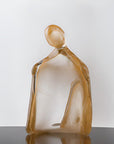 Glass sculpture of a woman with 24K gold dust on a white background titled HER from Duccio Di Segna, available at Spacio retail stores in Mumbai & Kolkata.