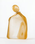 Glass sculpture of a woman with 24K gold dust on a white background