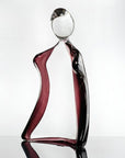 Glass sculpture of a man with a violet tint on a white background titled HIM from Duccio Di Segna, available at Spacio retail stores in Mumbai & Kolkata.
