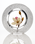 Decorative crystal sculptural vase with a flower inside on a white background