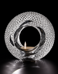 Decorative crystal sculptural candle holder with a candle inside on a black background from Duccio Di Segna available at Spacio retail stores in Mumbai & Kolkata
