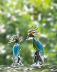 Artistic glass parrots by Duccio Di Segna, luxury crystal sculptures placed in a garden setting, now available at Spacio India