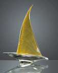 Crystal Medium Transparent Gold Sailing Boat by Duccio Di Segna, designed with a graceful golden sail and reflective base, showcased at Spacio India.