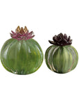 Two decorative glass pumpkins on a white background