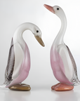 Two crystal duck figurines on a white background