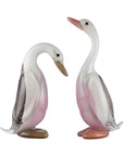 Two glass duck figurines with pink and white colors on a white background