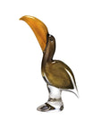 Glass sculpture of a pelican with a large beak on a white background