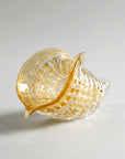 Angled view of amber and gold Cornucopia crystal sculpture by Duccio Di Segna, luxury glass art available at Spacio India