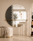 Modern interior design with a round mirror, ottoman, decorative light, marble floor totem, modern furniture and decorative plant.