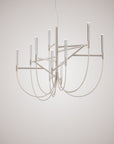 Modern chandelier with white metal design on a plain background