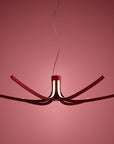 Modern chandelier with red accents on a pink background