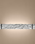 Decorative wall light fixture with textured wall on a beige background