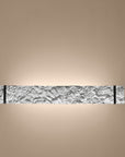 Decorative wall light fixture with textured wall on a beige background