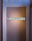 Decorative wall sconce on a wall with a textured finish