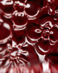 Close-up of red ceramic flowers of the Fregio lamp from Foscarini with a glossy finish