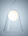 Modern pendant light with a clear glass shade on a gray background