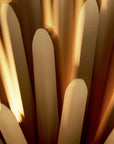 Close-up of Foscarini Sun light of love suspension lamp like a star burst in golden finish available at Spacio retail stores in Mumbai & Kolkata.