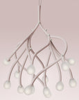 Modern chandelier with white branches on a pink background