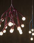 Modern chandelier with multiple light bulbs on a dark background
