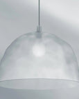 Silver pendant light against a gray background