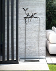 A modern outdoor living area with a white sofa and chairs adorned by a Gardeco Bronze Sculpture Love Birds (Limited Edition).