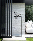 A modern outdoor living area with a white sofa and chairs adorned by a Gardeco Bronze Sculpture Love Birds (Limited Edition).