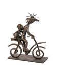 Bronze sculpture of a couple on a bicycle with a white background