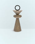 Decorative stone sculpture with a circular top on a light blue background