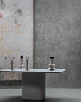 Table with decorative items against a textured wall