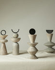 Set of five stone sculptures on a neutral background